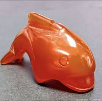 Front-angle view of polished carnelian dolphin showing head and fin detail