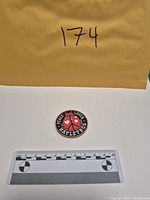 Full view of copper round with scale and lot envelope
