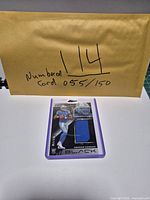 Front view of card in holder showing player image and fabric patch
