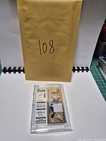 Card in case front view below envelope marked 108