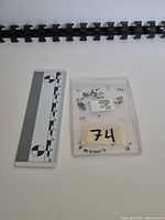 Packet of sapphires beside scale ruler showing size and packet label