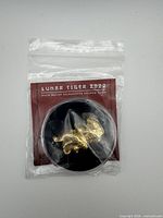 Front of sealed package showing Lunar Tiger coin in capsule and title card