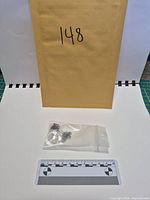 Full lot showing envelope, necklace in bag, scale