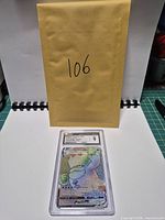 Front view of CGC-slabbed Galarian Darmanitan VMAX card with envelope behind