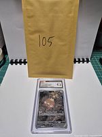 Front view of encapsulated Stunfisk card with envelope