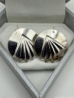 front view of both sterling silver seashell earrings in box