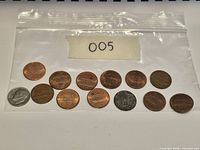 Bagged lot of twelve Lincoln Memorial cents (reverse shown) and one Roosevelt dime