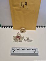 All three brooches with scale