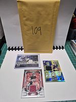 All three football memorabilia cards with envelope backdrop