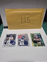All three sleeved memorabilia cards front view
