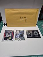 Overview of all three sleeved memorabilia cards