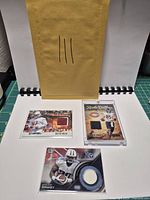 Overall lot with three memorabilia cards and mailing envelope