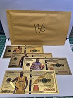 Fronts of three gold-tone souvenir notes with player images visible