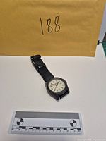 Full view of wristwatch with ruler for scale