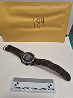 Full watch with envelope and scale for size