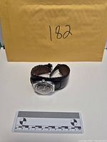 Whole watch coiled, showing envelope with lot identifier