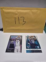 Envelope with lot number and two sleeved cards in front