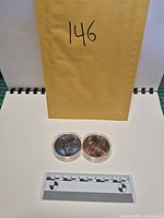 Lot overview with envelope number and joined capsule containing two rounds