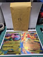 Both jumbo cards on cutting mat with envelope for scale