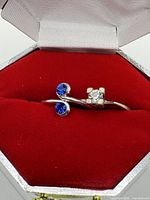 Both rings in red octagonal box showing stone settings