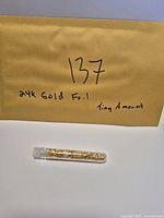 Envelope label and sealed vial of gold foil