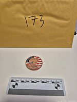 Round with scale and envelope showing lot identifier