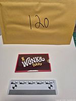 Front view of Wonka Bar sleeve with scale