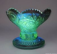 Bowl under UV light showing green fluorescence, entire piece visible