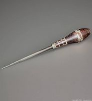 Full view of blade hone showing steel rod and mahogany handle with sterling bands