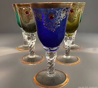 Frontal group view showing colour variety, gold gilding, twisted stems, red jewels