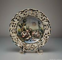 Front view showing painted cherubs and reticulated gilt rim