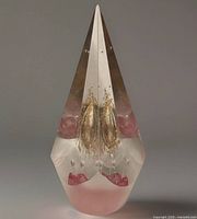 Front view showing red and gold jellyfish inclusion inside clear faceted teardrop