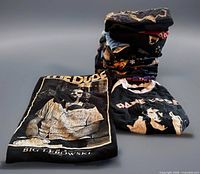 Stack of folded graphic T-shirts showing various prints