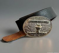 Front view showing embossed buckle design and attached leather belt