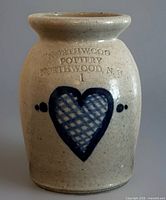 Front view showing heart motif and impressed lettering