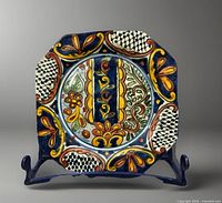 Front view showing full painted design of plate on stand