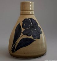 Front view of salt-glazed bud vase showing cobalt blue floral design