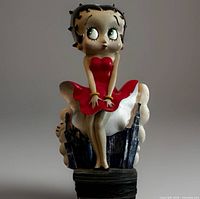 Front view of Betty Boop figurine showing red dress and seated pose