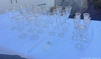 Full grouping of 26 clear glass stemware pieces on table