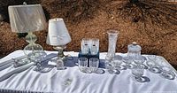Full lot on table showing lamps, glasses, vase, bowls and jar