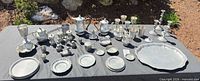 All items arranged on table outdoors showing scale and variety