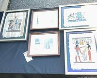 Group shot of all five framed artworks on display surface