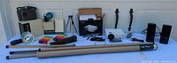 Full lot overview showing camera, flash, film packs, stands, projector, speakers and accessories on table