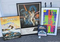 Group shot showing all framed posters and metal sign