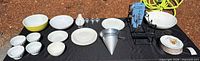 Overhead view of entire lot showing bowls, plates, strainer, wine rack, utensils, glasses