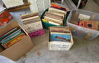 Four containers filled with stacked LP and 78 RPM records