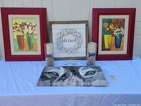 Entire lot front view showing framed prints, sign, candle holders, canvas, dishes
