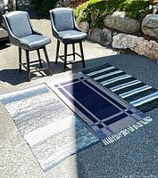 Two bar stools and three runner rugs laid on driveway