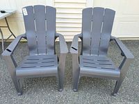 Front view of both gray plastic Adirondack chairs