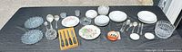 Entire lot laid out showing dinnerware, flatware, steak knives in tray and glassware pieces